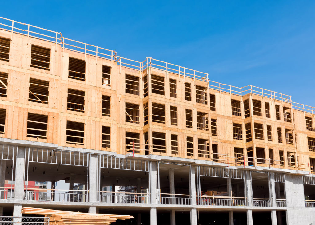 Why are lumber prices so high in the U.S., and what is its effect on construction?